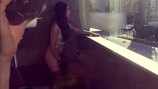 Gostosa masturbates on balcony.