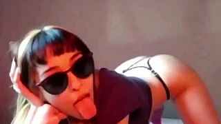 I am bonneyuwu inserting marbles into a condom on the bed