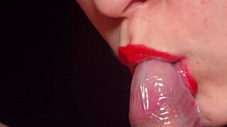 Red lips devour condom-wrapped cock close-up