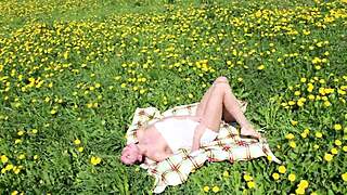 beautiful ananta shakti masturbates her pussy on a sunny field with dandelions