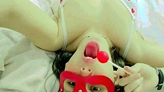 Hot and naughty student sucking lollipops at the bed wearing new white lingerie